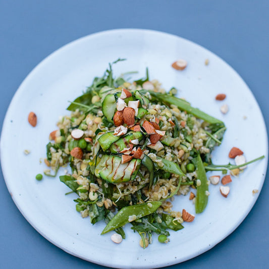 GRILLED ZUCCHINI, BROCCOLI + PEA SALAD WITH QUINOA, SOFT HERBS, ROCKET + PRESERVED LEMON DRESSING